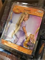 Photo showing Rapunzel wig in original packaging with Disney branding and character image.