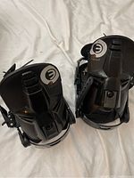Top view of the pair of black Head snowboard bindings showing the highbacks with logos and general condition.