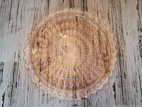 Top-down view showing the intricate cut glass pattern and clear pink color.