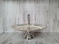 Front view of the WR Midwinter Indian Tree dessert tray on its metal pedestal stand, showing the floral pattern and scalloped gold rim.