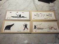 Overview photo of all four drawings arranged on a flat surface showing the entire lot