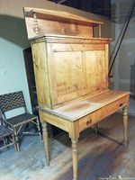 Full front view of the two-piece wooden desk showing both upper and lower sections assembled.