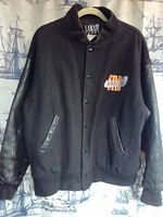 Front view of vintage Lamasz Sport wool and leather jacket showing black wool body, leather sleeves, snap buttons, and front left chest logo reading 'STAR'.