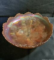 Top-down view of the iridescent marigold carnival glass bowl showing the windmill and floral embossed patterns.