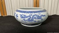 Exterior side view showing hand-painted blue dragon motif encircling bowl