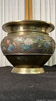 Front view of the antique Chinese champleve cloisonne enamel planter showing colorful floral enamel work on metal.