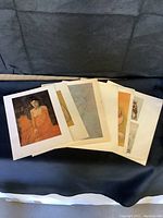 Photo showing all six classical art prints laid out on a flat surface.