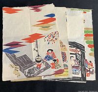 Stack of nine vintage Japanese stencil art pieces with visible colorful folk scene designs and geometric borders