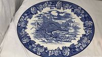 Full view of large blue and white oval platter showing turkey scene and floral border