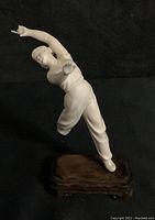 Frontal view of vintage Japanese alabaster colored ballerina statue, showing figure's pose and expression.
