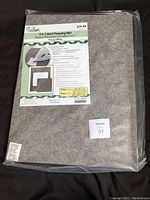 Photo showing the packaged Tailor 2 in 1 Wool Pressing Mat with label and price tag of $79.99.