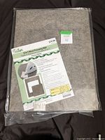 Front view of the packaged 2-in-1 Wool Pressing Mat with label and price tag visible.