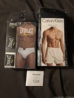 Photo of Calvin Klein 3-pack boxers and Everlast 3-pack briefs showing front packaging and size labels.