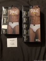 Two boxes of Everlast men's briefs, one 3-pack and one 6-pack, featuring black, white, and grey briefs visible through packaging showing waistband logo.