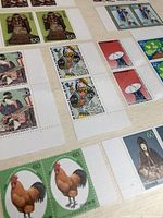 Close-up photo showing stamps with traditional Japanese images, a satellite dish, and playing card motifs