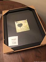 Black Lawrence Frames shadow box 11x14 with cardboard corner protectors and interior linen backing visible through glass.