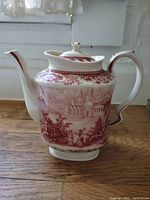 Side angle view of the Venetian transferware teapot showing the spout, handle, detailed scene, and floral medallions.