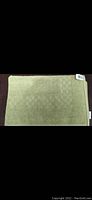 Photo of green bathroom floor towel showing full towel and textured pattern