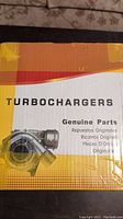 Box labeled Turbochargers Genuine Parts with multilingual text and image of a turbocharger