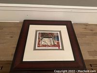 Framed Tom Thomson print "The Tent" laying horizontally showing full frame and matting.