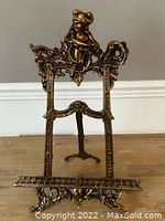 Full view of brass strut frame showing entire structure and base support