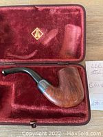 Close up of Blumenfeld's Best briar pipe resting in original red velvet box with B B B gold logos.