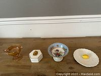 View of all four decorative pieces arranged on wooden surface.