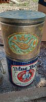 Photo of Blue Boy Fresh Fruit tin with hand painted Pennsylvania Dutch tin stacked behind