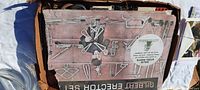 Photo of the vintage Gilbert Erector Set original box showing illustrations of a boy holding built models and various metal components around him.
