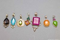 All seven assorted vintage 925 silver pendants with various stones.