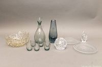 All items laid out together, showing the Humppila crystal bowl, Kazel smoked glass vase, Holmesgaard liquor set and Iittala plates.