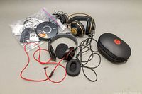 Full lot overview showing all headphones, CD player, plastics bag with cables and Beats case.