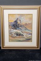 Full view of framed watercolour painting depicting mountainous landscape with a cream frame and double mat.