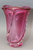 Front view of vintage pink freeform blown glass vase with clear edges and flowing curves.
