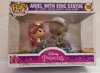 Front view of the Funko Pop Moments box showing Ariel with Eric statue figure inside, model number 1169, new in box.