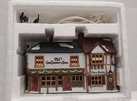 Original white styrofoam packaging with electrical cord and light socket included.