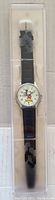 Full view of new Mickey Mouse watch in original packaging showing black strap and silver-tone case.