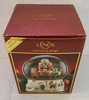 Original red Lenox box with yellow 2011 Annual edition sticker, showing front image of the snow globe and branding.