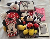 Full lot including plush dolls of Mickey and Minnie Mouse, Minnie Mouse shaped backpack, a pink Minnie Mouse t-shirt, a Mickey Mouse themed carrying case, and a boxed Disney D-Tech iPhone 4 case and screen guard.