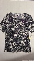 Full view of LuLaRoe Disney Jack Skellington top with attached tag, size Medium, showing print pattern.