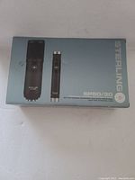 Photo of the original product box with images and branding of Sterling SP50/30 condenser microphones, showing product naming and visual details of mics.