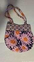 Full view of the Vera Bradley quilted floral fabric handbag showing the overall shape and designs with straps.