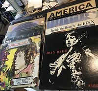 10 vinyl LP records fanned out showing front covers, includes America, The Fixx, Joan Baez, Tina Turner, Rough Trade, Mike Quatro, and Supertramp with some covers showing wear and tear.