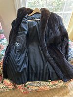 Interior view showing black striped satin lining and label