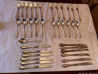 Main flatware pieces: forks, spoons, knives on white background