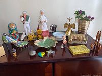 Overview of all small figurines and collectibles arranged on wooden surface.