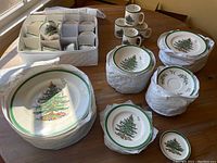 Overall view of stacked dinner plates, salad plates, bowls, mugs, teacups and saucers with protective wrapping