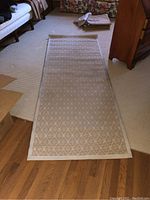 Full view of taupe hallway rug laid out on floor showing overall shape and pattern.