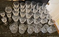 Group shot showing all 35 Waterford crystal glasses of various styles and sizes