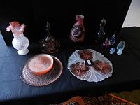 Full view of all glassware including vases, plates, decanter, and small bottles